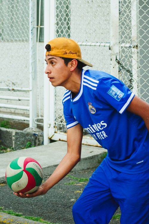 Free Portrait of a young volleyball player preparing to serve during an outdoor game in Mexico City. Stock Photo