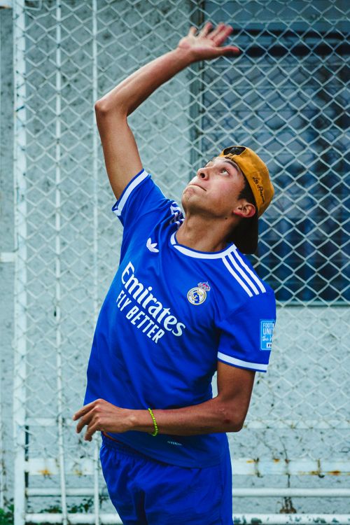 Free Young athlete in a vibrant jersey strikes during a volleyball match in Mexico City. Stock Photo