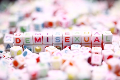 Free Vibrant alphabet blocks spelling 'Demisexual' with a blurred background for text space. Stock Photo