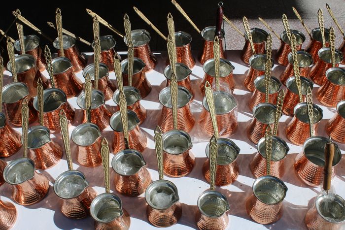 Copper pots arranged in a grid, shot from above &mdash; photo by Oguz Dik on Pexels