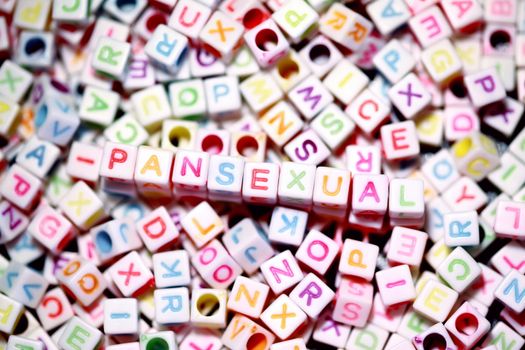 Brightly colored alphabet blocks spelling 'pansexual,' symbolizing inclusivity and diversity.