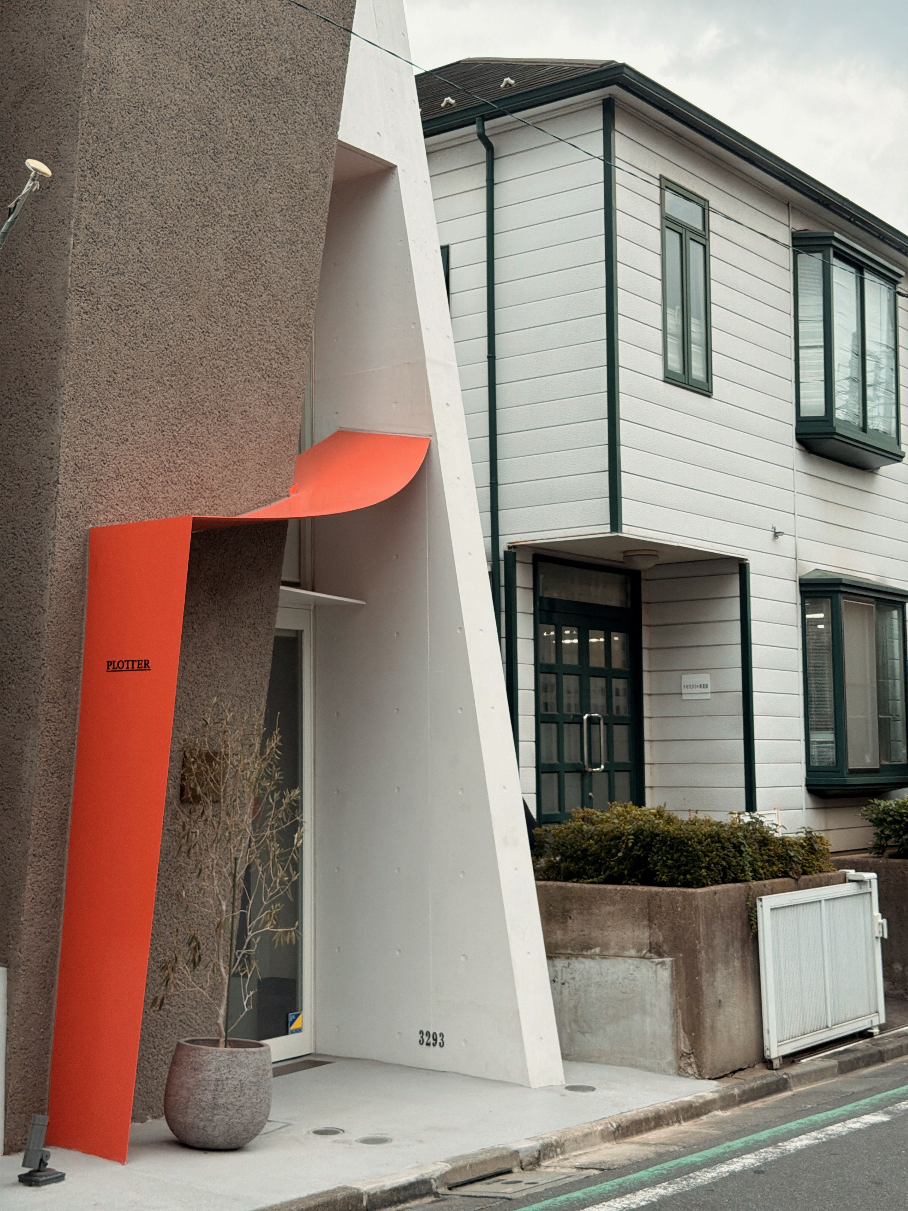 Minimalist architectural design of a building facade with modern elements in Tokyo, Japan.