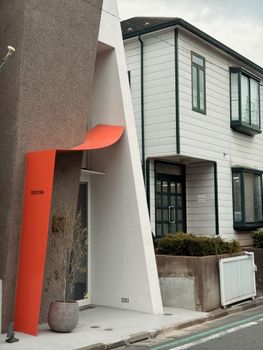 Minimalist architectural design of a building facade with modern elements in Tokyo, Japan.