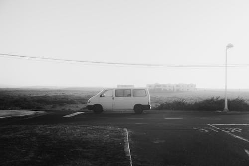 Grayscale Photo Of Van On Road