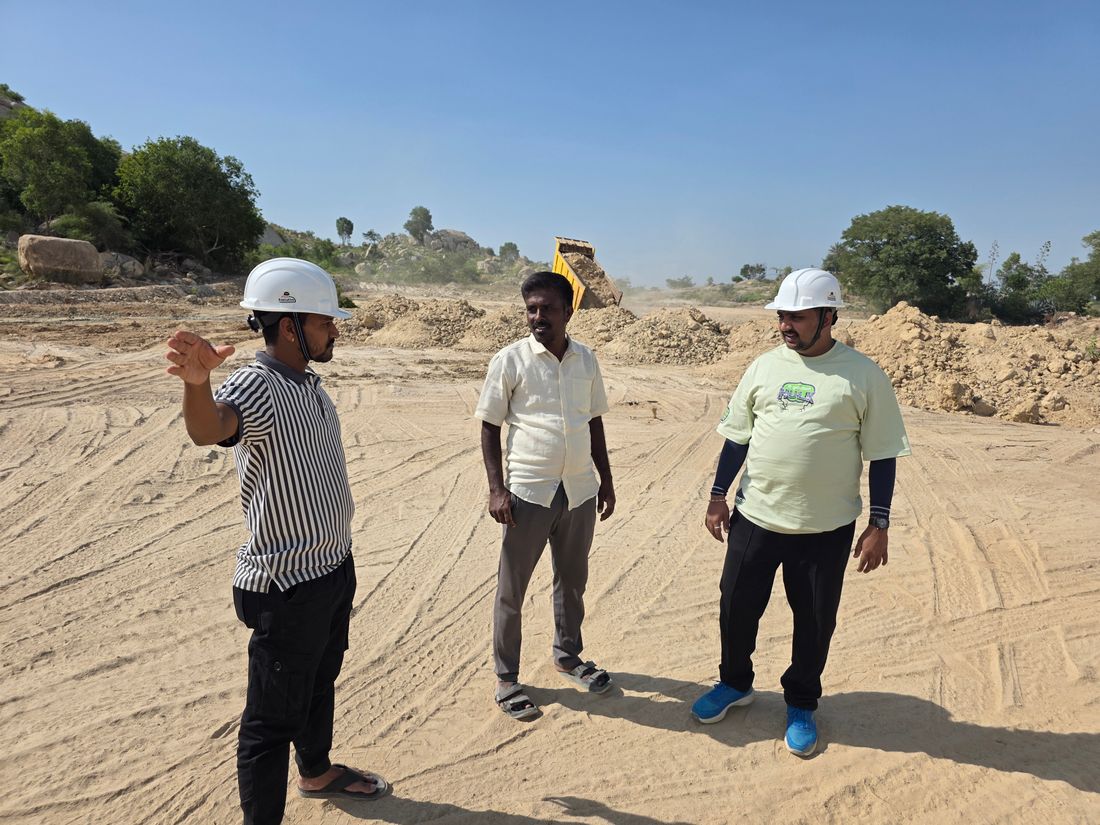 Engineers in hard hats having a construction site meeting