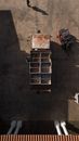 Aerial view of shabby truck with empty boxes parked in loading area with forklift and people nearby