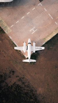 Light aircraft on edge of helipad