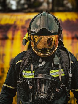 A firefighter wearing protective gear and helmet, ready for action.