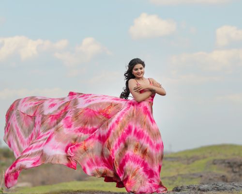 Free Elegant woman in a pink dress posing outdoors, embracing nature and style. Stock Photo