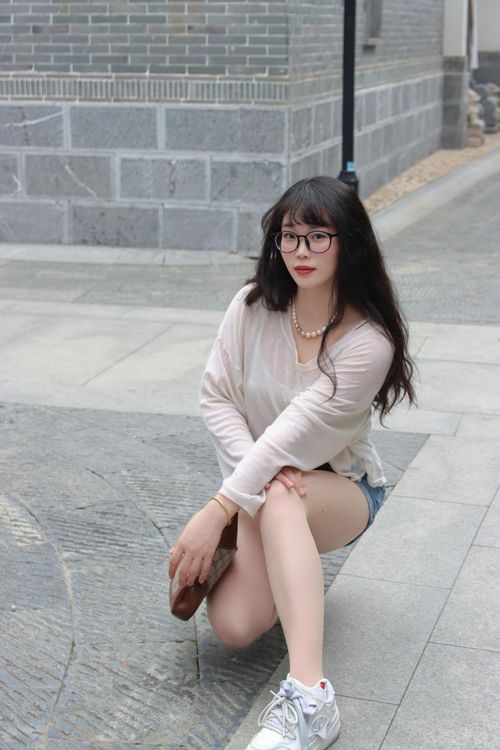 Free Young woman posing in urban Nanjing, China street, wearing casual fashion. Stock Photo