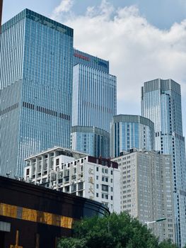 Skyscrapers rise in Tianjin, China showcasing modern architecture and urban development under a bright blue sky.