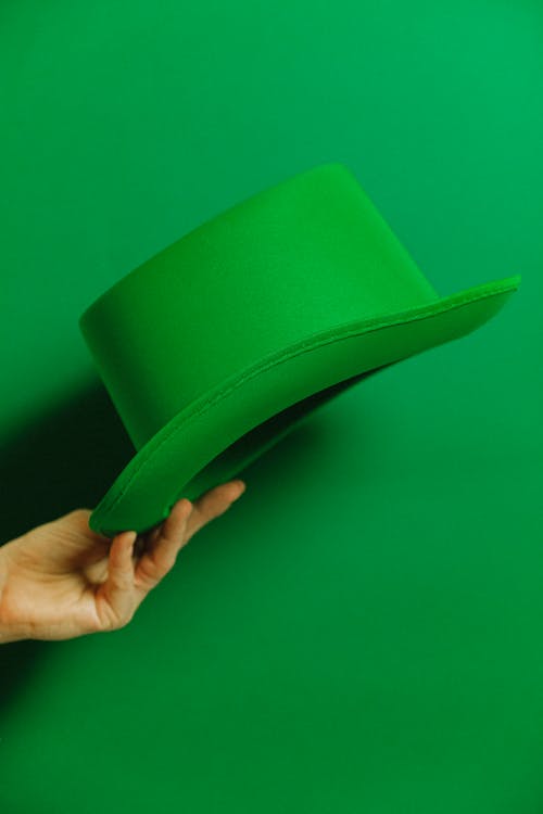 Person Holding Green Hat