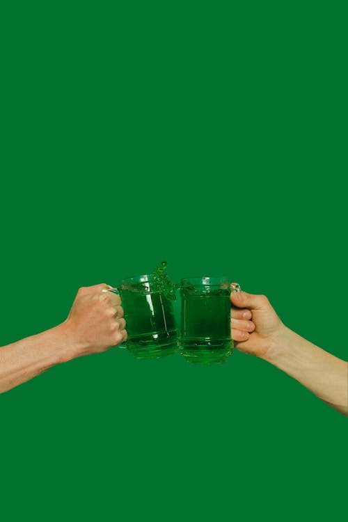 Person Holding Clear Glass Mug