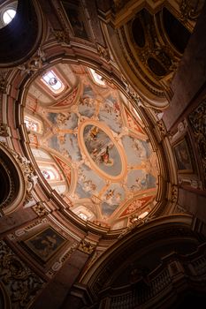 Ornate Baroque dome ceiling with intricate frescoes in a historic church in Malta