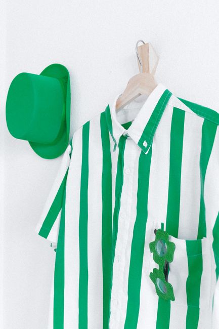 Vibrant green and white striped shirt with matching hat, perfect for celebrating St. Patrick's Day.
