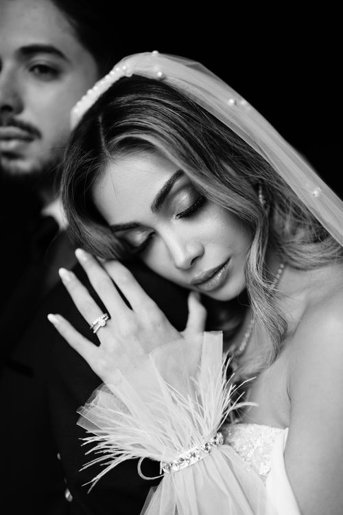 Free A stunning black and white portrait of a bride and groom in a tender moment. Stock Photo