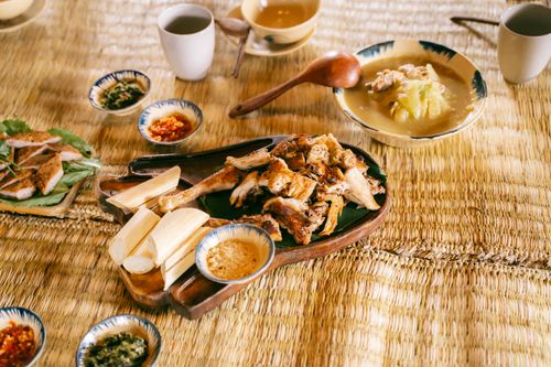 Free A delicious spread of traditional Asian dishes served on a bamboo mat with a rustic setting. Stock Photo