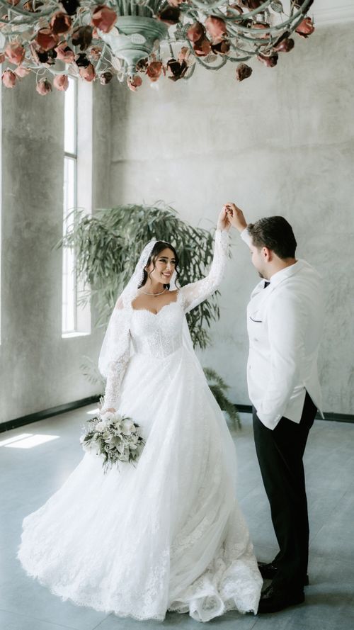 Free A beautiful bride and groom dancing indoors, capturing a serene wedding moment. Stock Photo
