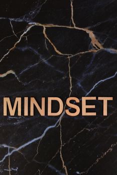 Wooden 'Mindset' text on a dark elegant marble background symbolizing modern inspiration and motivation.