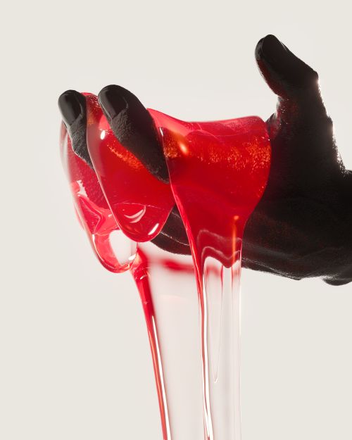 Free A striking image of glossy red liquid flowing elegantly between sculpted black hands, showcasing modern fluid dynamics. Stock Photo