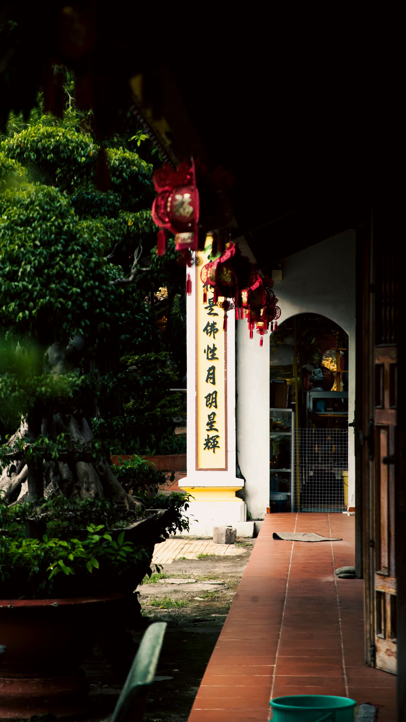 Exterior view of a Vietnamese temple with traditional decorations and lush greenery.