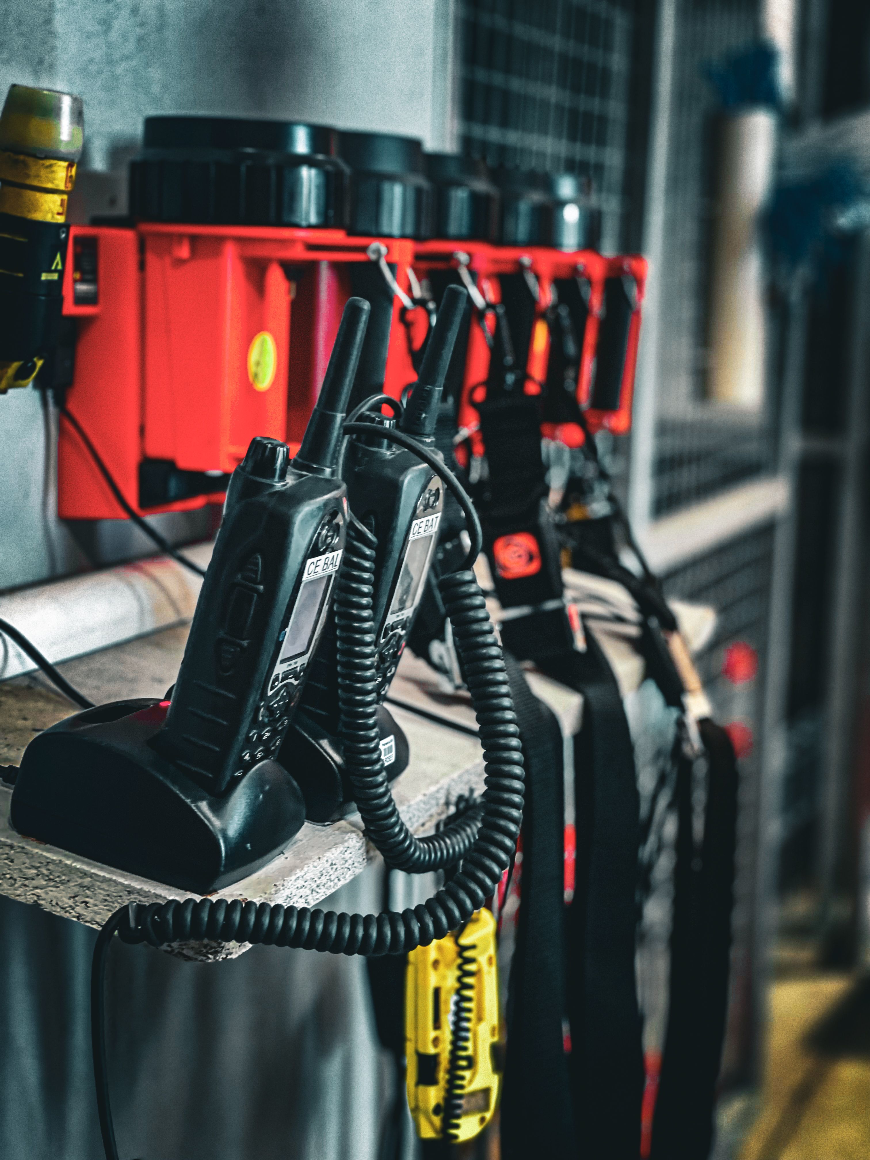 Close-up of communication radios and equipment in an industrial setting, showcasing organization and technology.