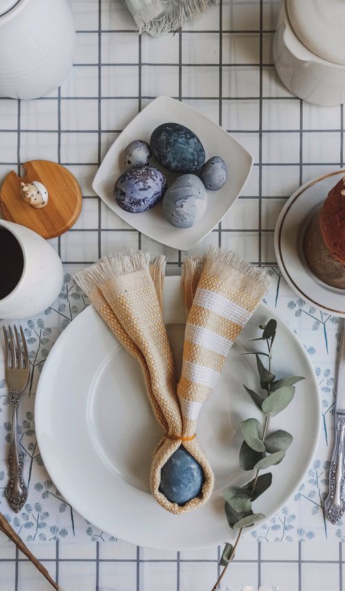 Free Festive Easter table setting with decorative eggs and rustic decor, perfect for spring celebrations. Stock Photo