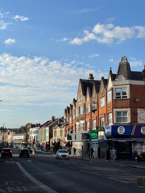 Free A vibrant street scene in South London showcasing classic British architecture under a bright blue sky. Stock Photo
