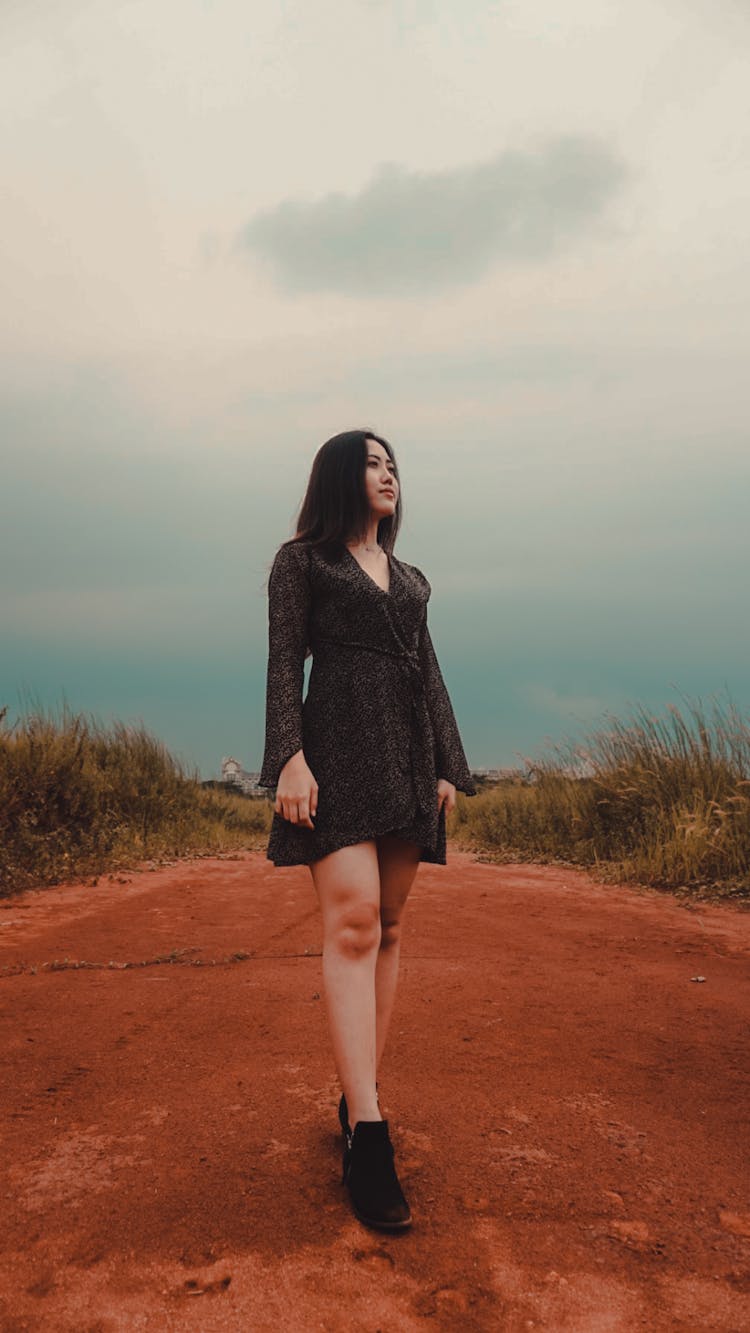 Fit Ethnic Woman Walking On Bright Dry Pathway In Countryside