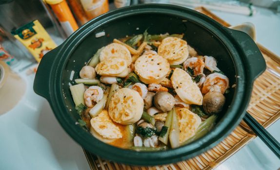 A flavorful seafood hotpot featuring tofu, shrimp, mushrooms, and vegetables.