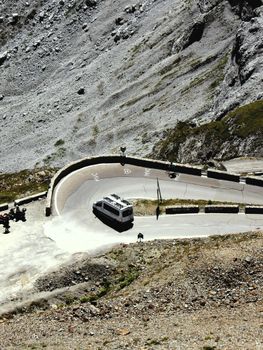 A camper navigates a winding mountain road in Trentino-Alto Adige, offering stunning views and adventure.