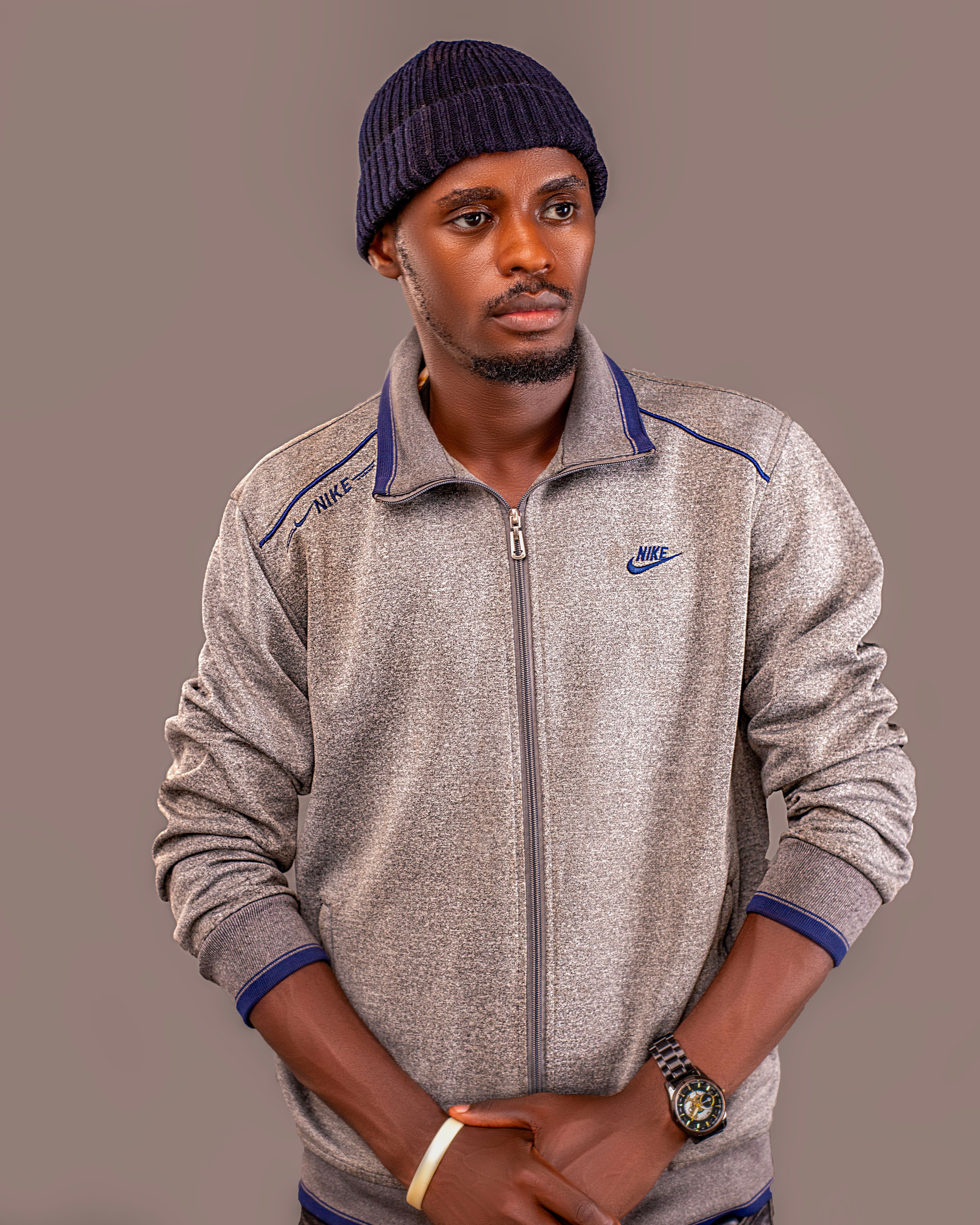 Young man in casual fashion, wearing a beanie and sweatshirt.