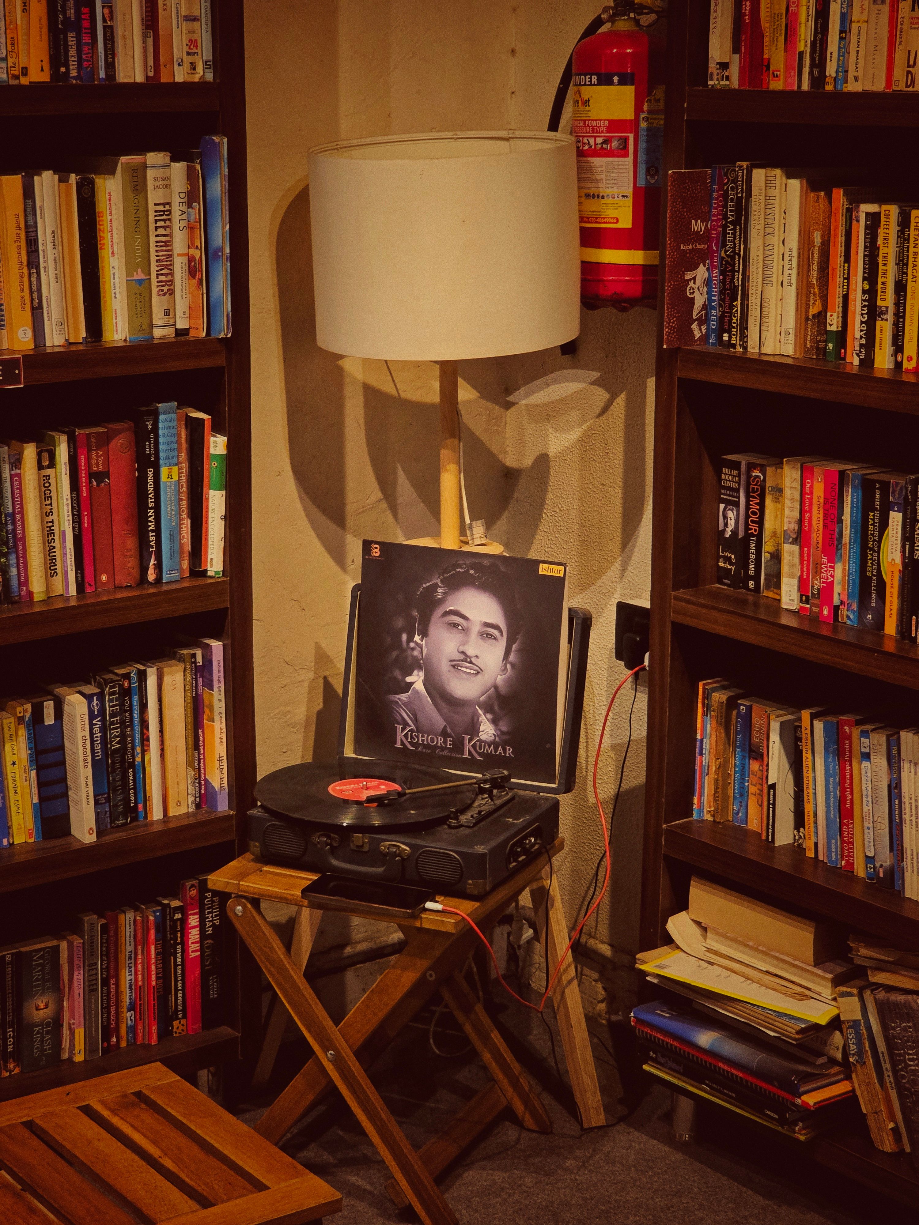 A cozy reading corner with bookshelves and a vintage record player adds a nostalgic touch.