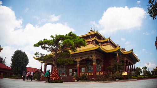 Free Beautiful Buddhist temple with intricate roof design in Da Lat, Vietnam, under a clear blue sky. Stock Photo