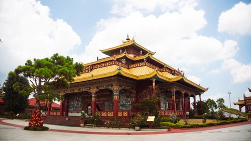 Free Traditional temple with golden roofs in Da Lat, Vietnam, under a clear blue sky. Stock Photo