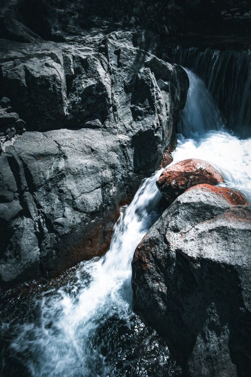 Free A dramatic waterfall cascades over rugged rocks in a natural setting, showcasing the beauty of flowing water and geological formations. Stock Photo