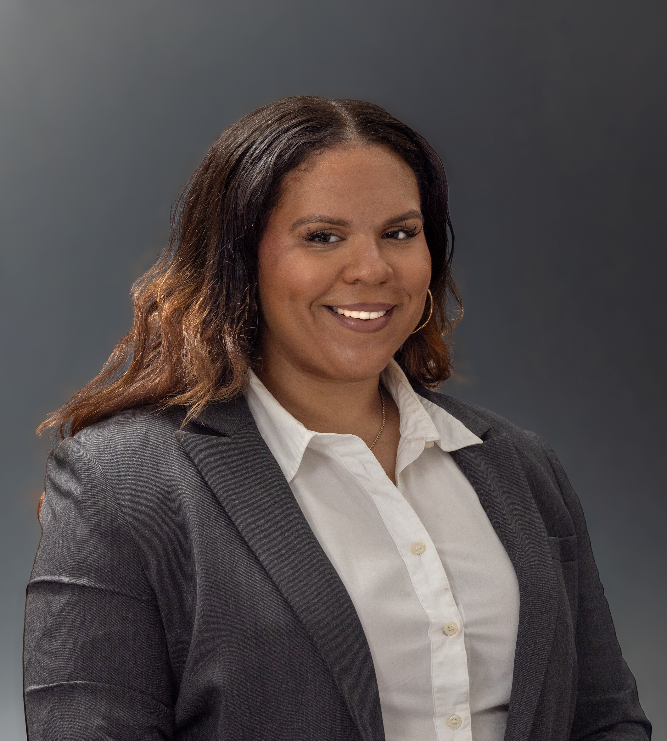Confident woman in grey suit with a friendly smile, ideal for corporate imagery.