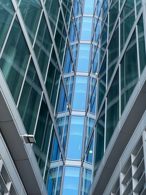 Free Striking view of glass facade architecture reflecting light in Milan, Italy. Stock Photo