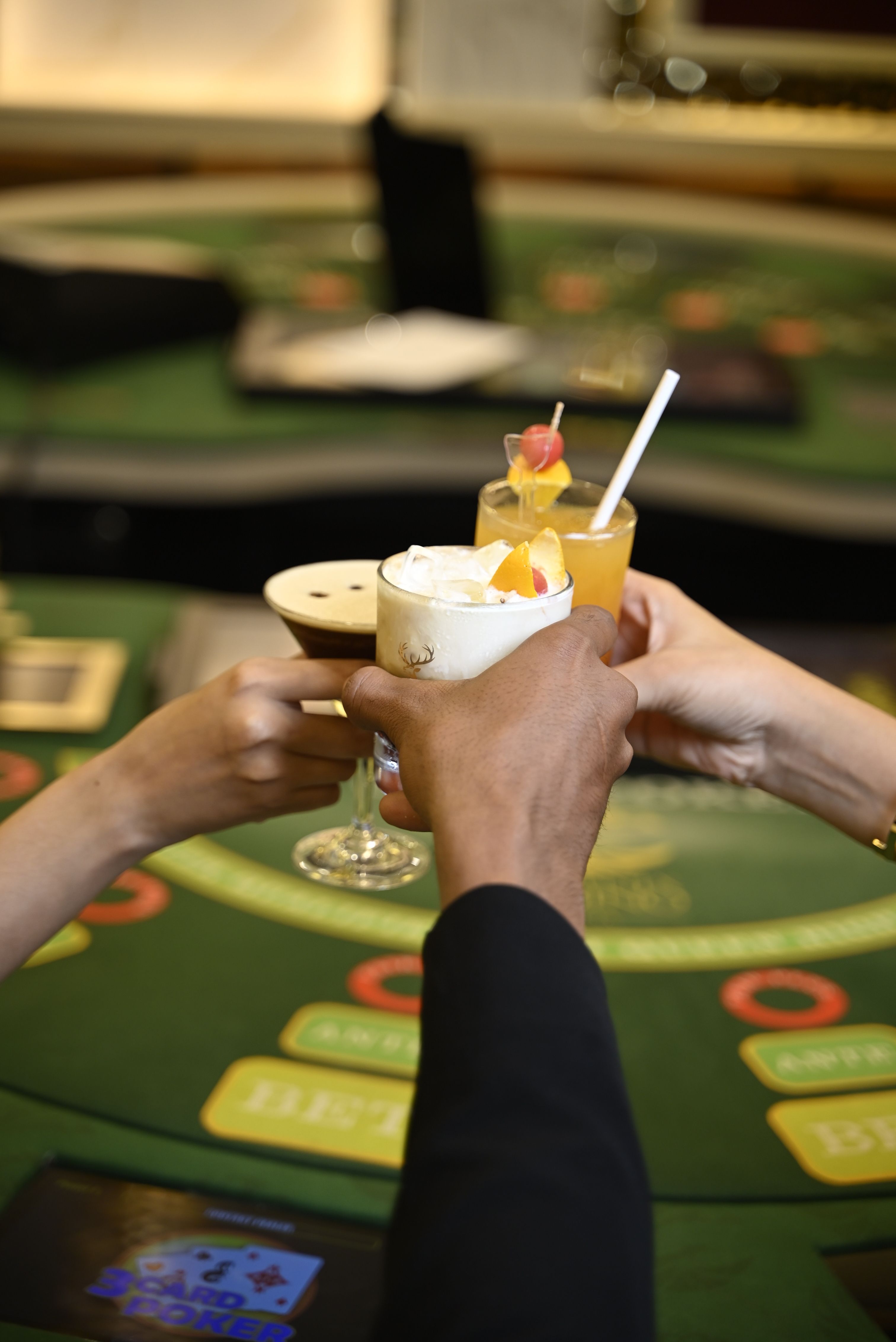 People enjoying cocktails at a vibrant Goa casino table setting.