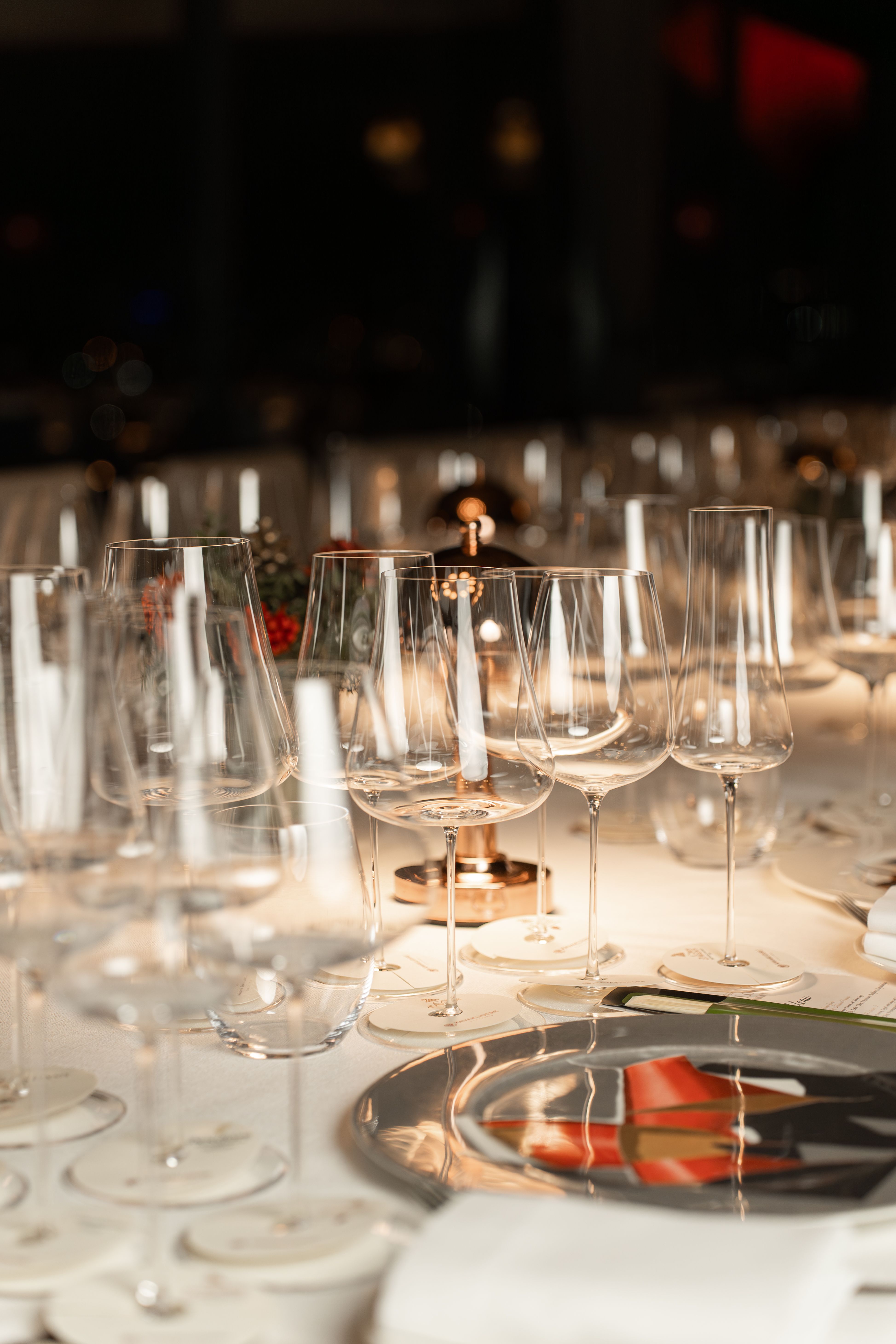 Elegant table setup featuring wine glasses and candles, perfect for fine dining.