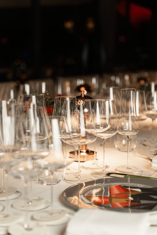 Free Elegant table setup featuring wine glasses and candles, perfect for fine dining. Stock Photo