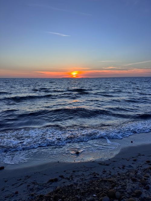 Free Captivating sunset over the Mediterranean Sea in Sardinia, Italy, with vibrant colors and gentle waves. Stock Photo