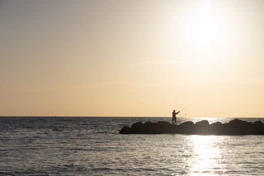 angler ocean sunset