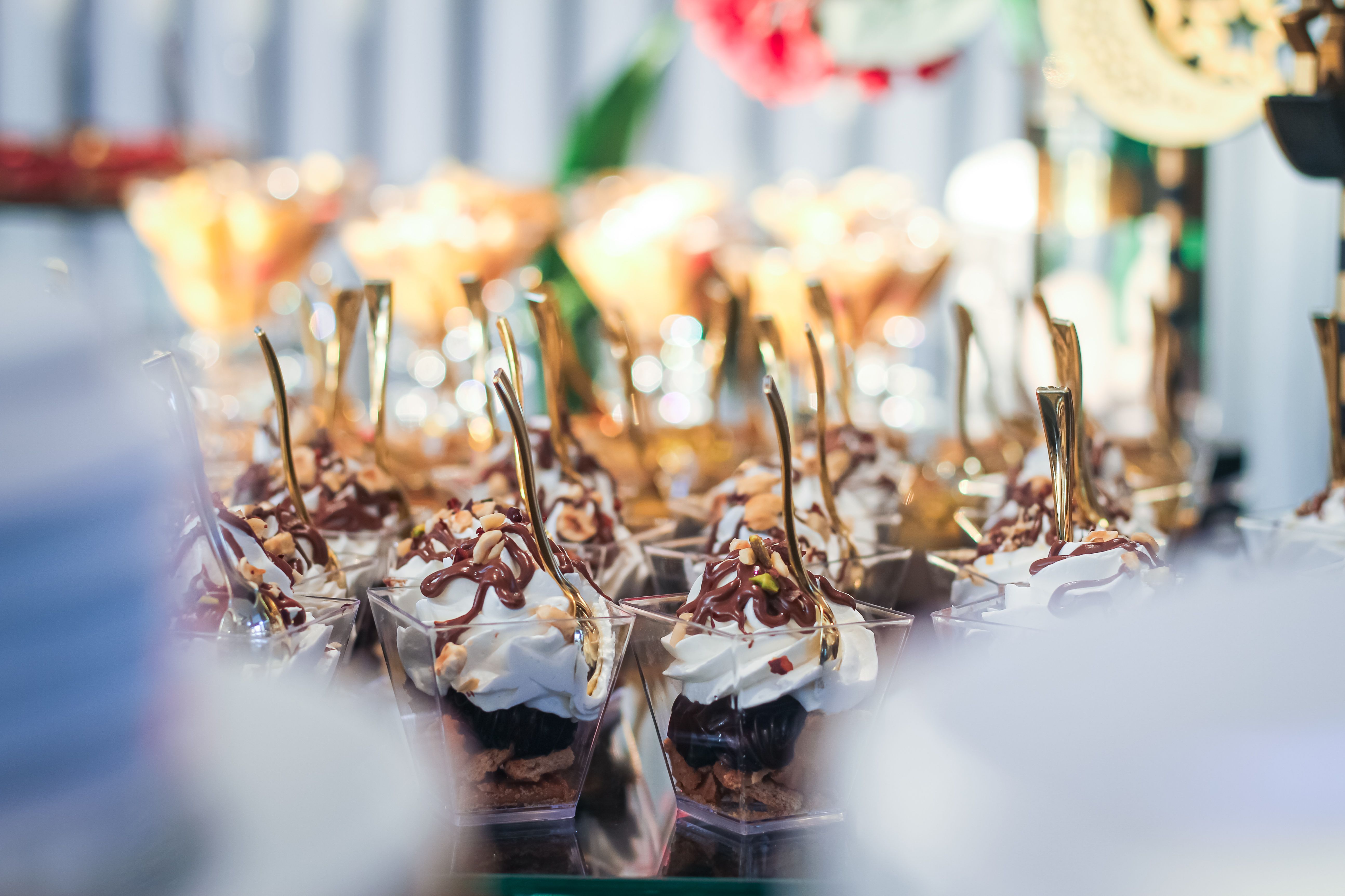A luscious display of assorted desserts with whipped cream and drizzle at a festive event.