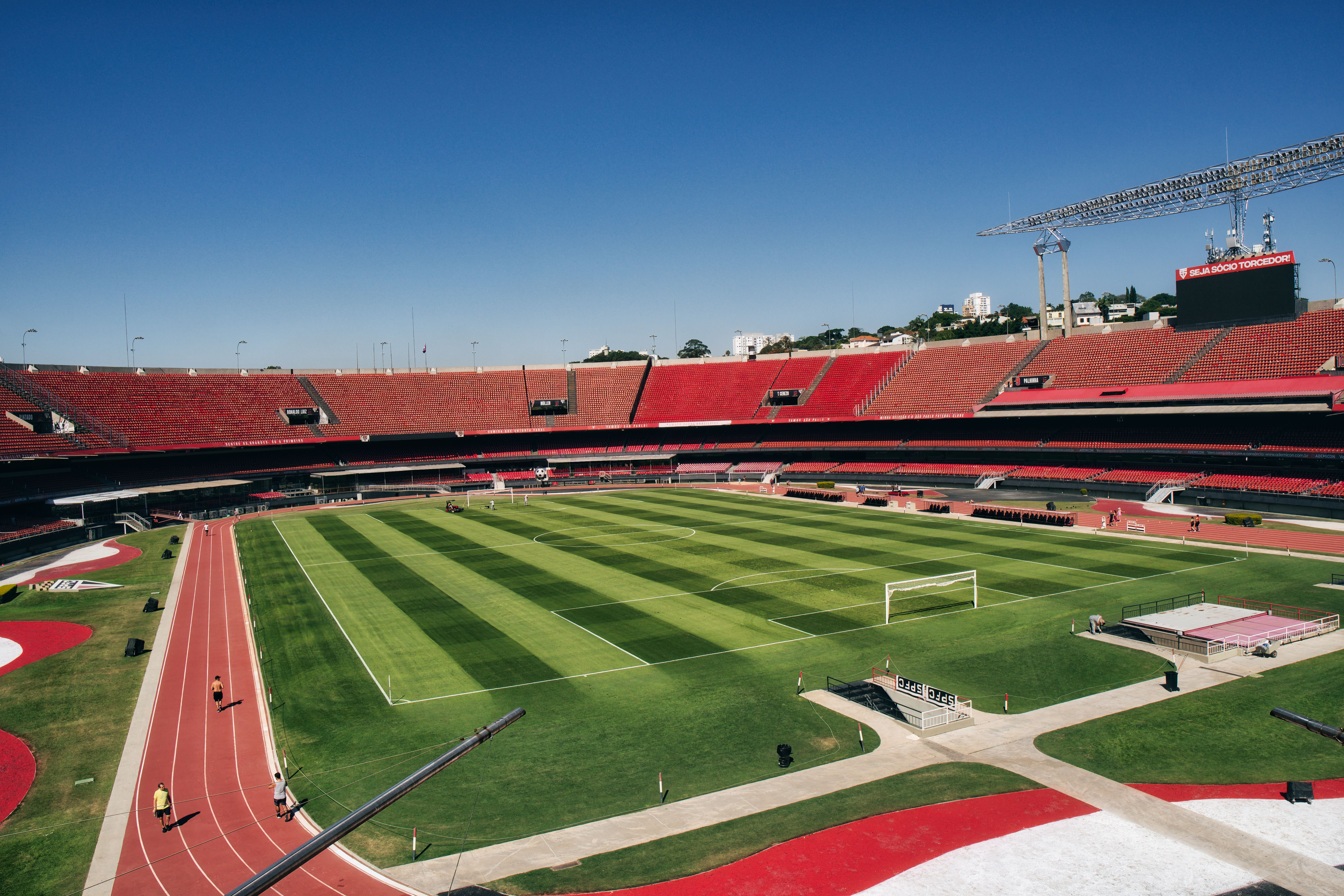 Elevated view of a football stadium with empty seats and lush green field.