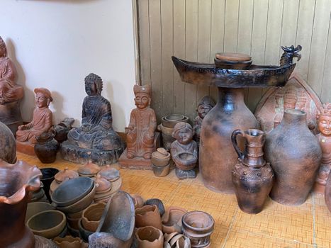 A diverse assembly of handcrafted Vietnamese pottery and cultural statues in a serene, traditional setting.