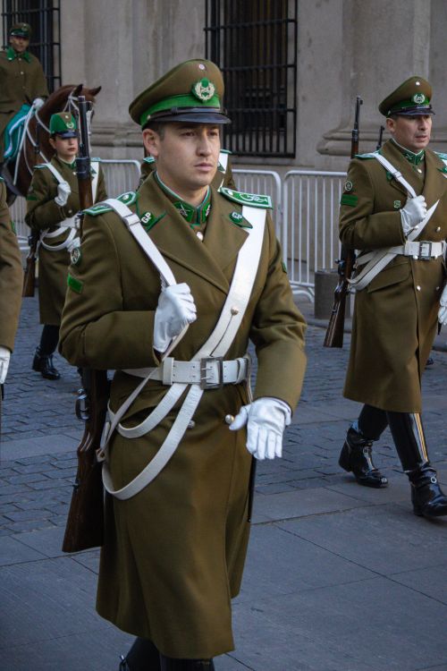 Free Military personnel in olive green uniforms march near La Moneda Palace, Santiago, Chile. Stock Photo