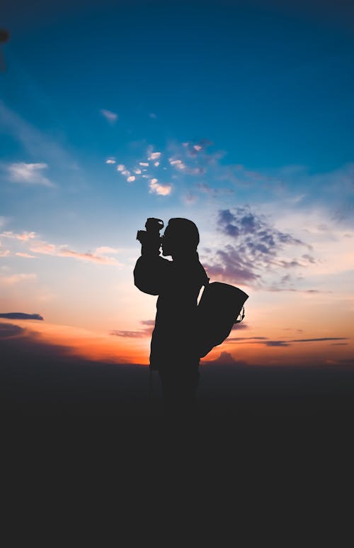 Silhouette Of Person Taking Photos