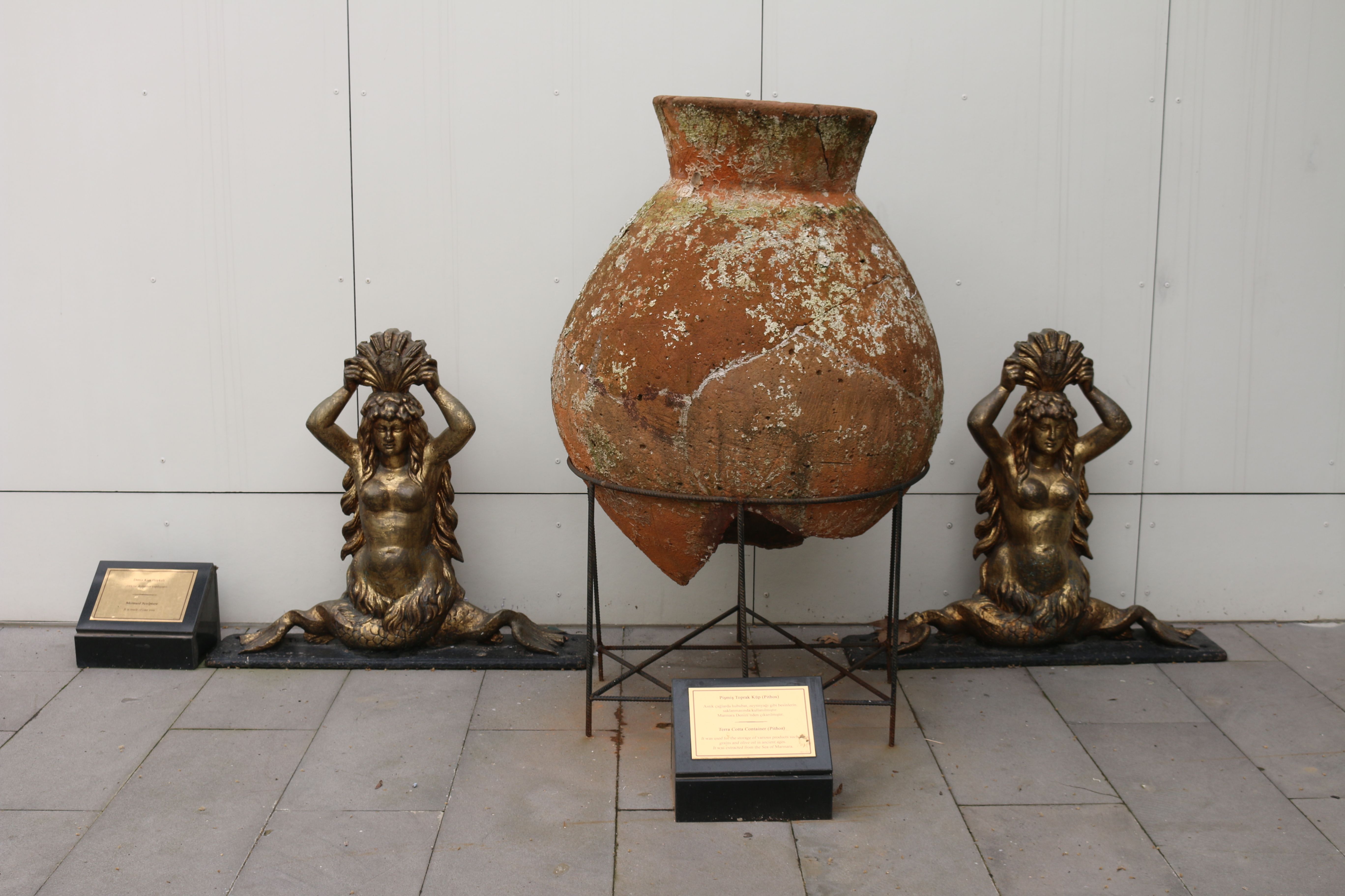 pair of ceramic and bronze sculptural vessels on a stone plinth