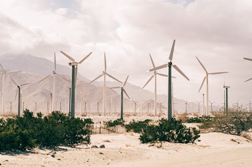 Wind Turbines On Brown Sand